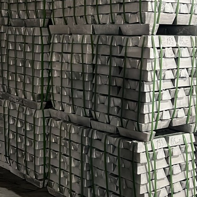 Stacked metal ingots bound with green straps